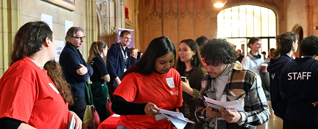 A prospective student talking to an ambassador at a PG open day.